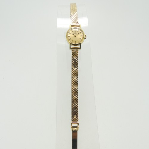 204 - A lady's Tissot Wristwatch, with champagne dial and baton markers, in a gold plated case with steel ... 