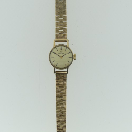 206 - A 9ct yellow gold Omega lady's Wristwatch, with circular silvered dial, gold baton markers and hands... 