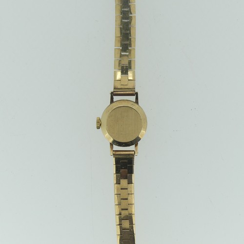 206 - A 9ct yellow gold Omega lady's Wristwatch, with circular silvered dial, gold baton markers and hands... 