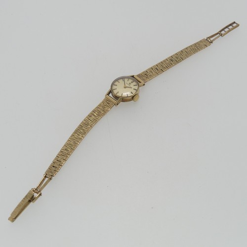 206 - A 9ct yellow gold Omega lady's Wristwatch, with circular silvered dial, gold baton markers and hands... 