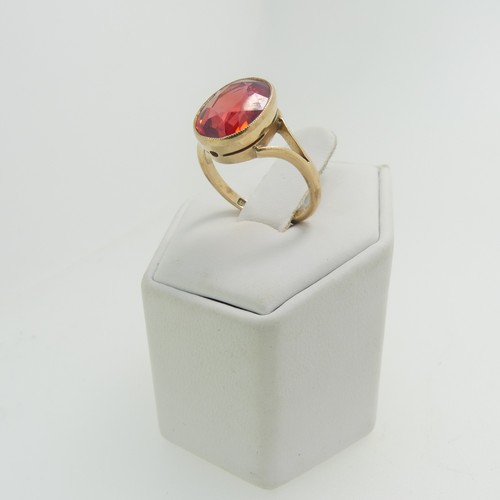 61 - A 9ct yellow gold Ring, set with an oval facetted red stone, possibly ruby, 11.8mm x 9.3mm, millegra... 