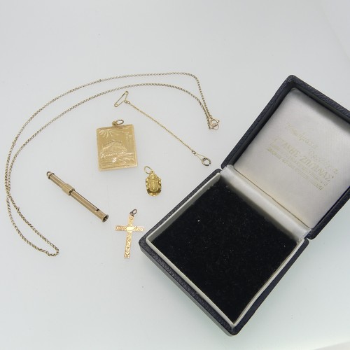 182 - A 9ct yellow gold retractable toothpick, 4.6cm long closed, together with a 9ct gold cross pendant a... 