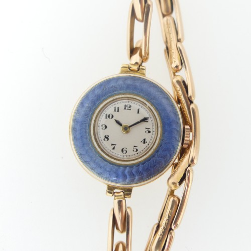 189 - An 18ct yellow gold lady's Wristwatch, with Swiss 15-jewels movement, the white enamel dial with Ara... 