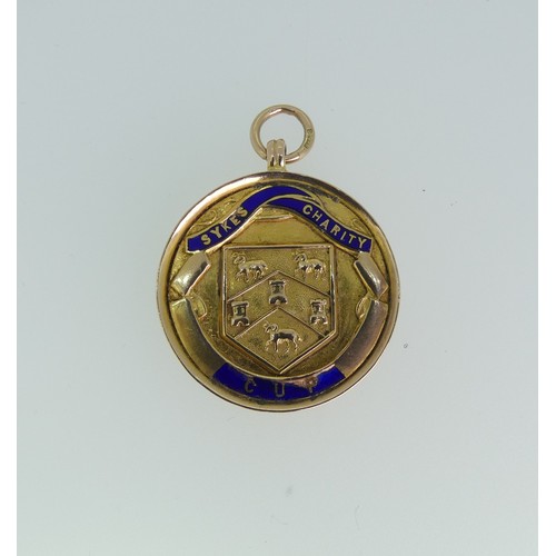 232 - A 9ct gold prize Fob Medallion, the front enamelled 'Sykes Charity Cup', the reverse with presentati... 