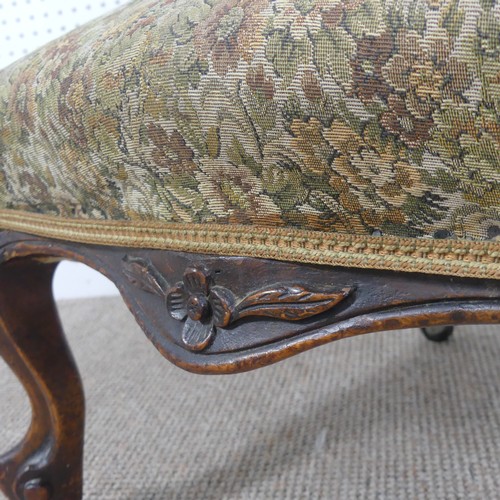 254 - A Victorian carved upholstered nursing chair, with floral carved press rail upon cabriole legs and s... 