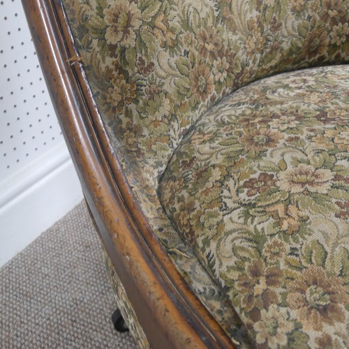 254 - A Victorian carved upholstered nursing chair, with floral carved press rail upon cabriole legs and s... 