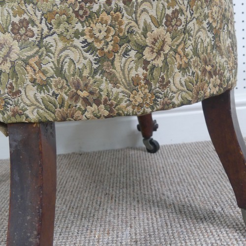 254 - A Victorian carved upholstered nursing chair, with floral carved press rail upon cabriole legs and s... 