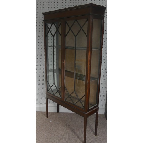 258 - An Edwardian mahogany display cabinet, with inlaid decoration, having three shelves enclosed by two ... 