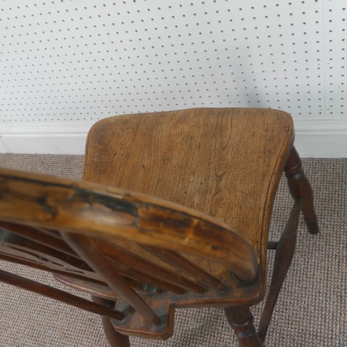 259 - A Late Victorian ash and elm Windsor Chair, stick-back with pierced splat above solid carved base up... 