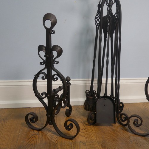 238 - A pair of wrought iron arts and crafts Fire Dogs together with arts and crafts Fire Irons and Stand,... 