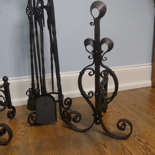 238 - A pair of wrought iron arts and crafts Fire Dogs together with arts and crafts Fire Irons and Stand,... 