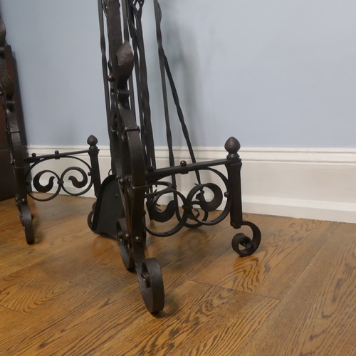 238 - A pair of wrought iron arts and crafts Fire Dogs together with arts and crafts Fire Irons and Stand,... 