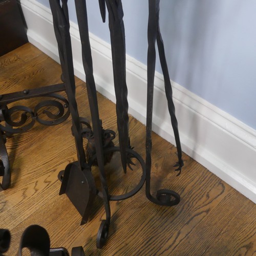 238 - A pair of wrought iron arts and crafts Fire Dogs together with arts and crafts Fire Irons and Stand,... 