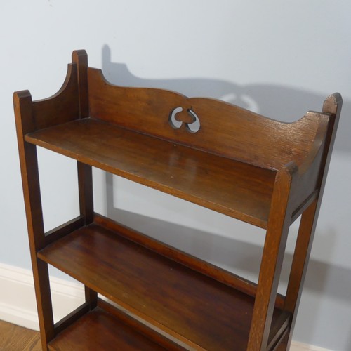 268 - A walnut free standing three shelved Arts and Crafts inspired Bookcase, with open back and pierced d... 