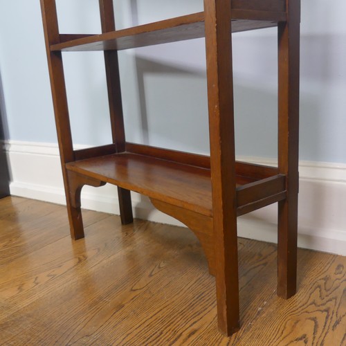 268 - A walnut free standing three shelved Arts and Crafts inspired Bookcase, with open back and pierced d... 