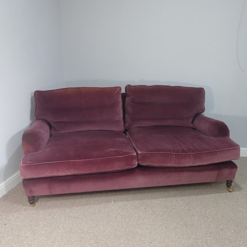 279 - A good quality Howard style, club two seater sofa, upholstered in purple with some fading near the t... 