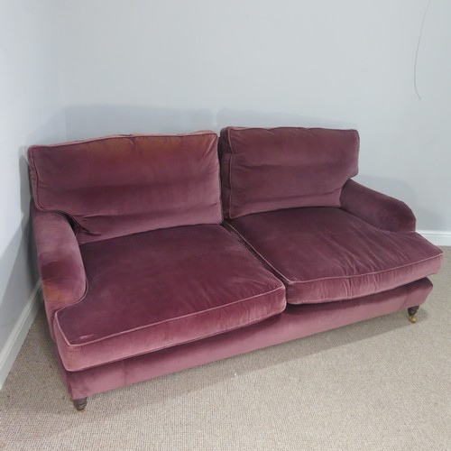 279 - A good quality Howard style, club two seater sofa, upholstered in purple with some fading near the t... 