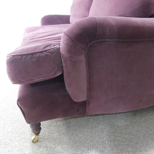 279 - A good quality Howard style, club two seater sofa, upholstered in purple with some fading near the t... 