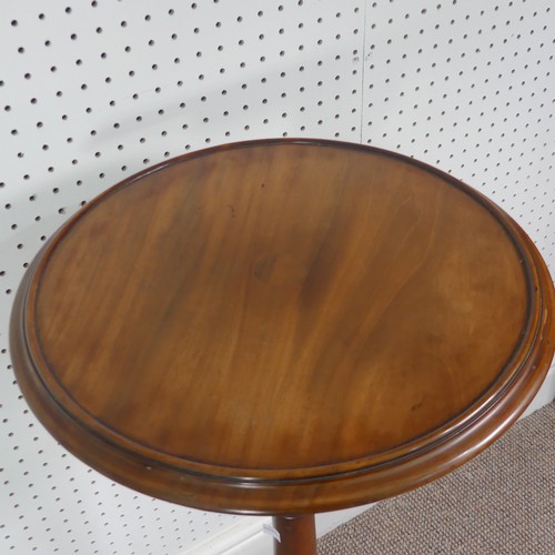 280 - A late Victorian mahogany plant stand/tall wine table, circular top upon turned column supported by ... 