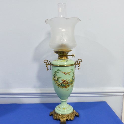 281 - An Edwardian glass and gilt-metal oil lamp, with  moulded shade above a green opaque oviform lamp ba... 