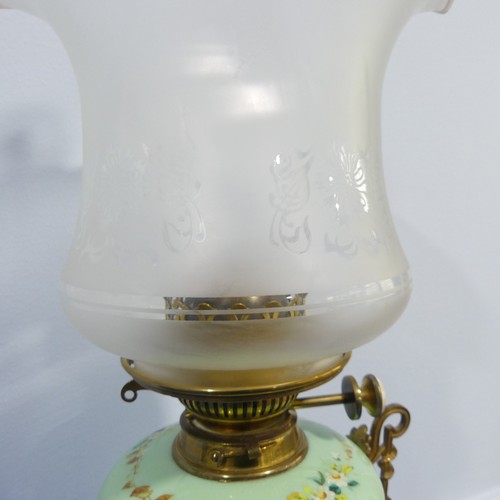 281 - An Edwardian glass and gilt-metal oil lamp, with  moulded shade above a green opaque oviform lamp ba... 