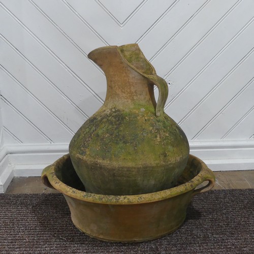 391 - A Large weathered terracotta jug and three handled basin, (Basin) W 54 cm x H 16 cm x D 54 cm, (Jug)... 