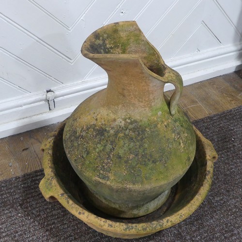 391 - A Large weathered terracotta jug and three handled basin, (Basin) W 54 cm x H 16 cm x D 54 cm, (Jug)... 