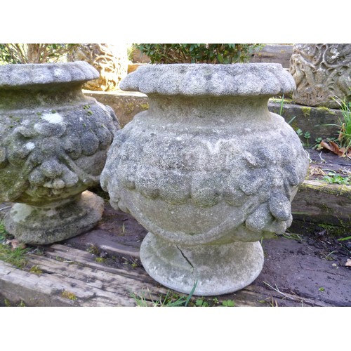 396 - A pair of reconstituted stone garden Planters, each planted with box topiary, note one planter has n... 