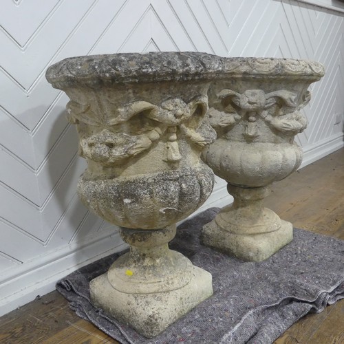 403 - A pair of Reconstituted stone classical Garden Urns with swag decoration raised on base, W 50 cm x H... 