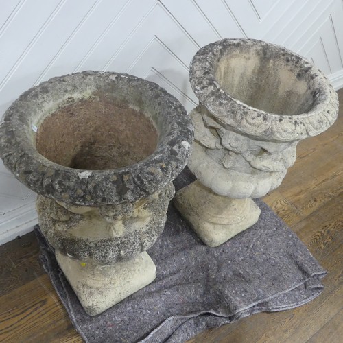 403 - A pair of Reconstituted stone classical Garden Urns with swag decoration raised on base, W 50 cm x H... 