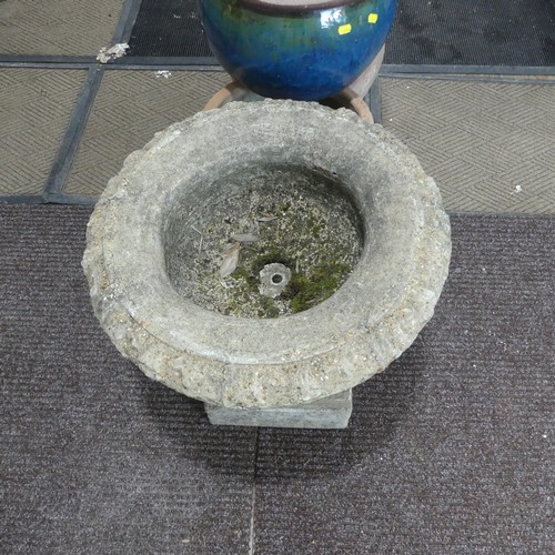 404 - A late 20th Century composite stone half fluted terrace vase or urn, on moulded plinth base and stan... 