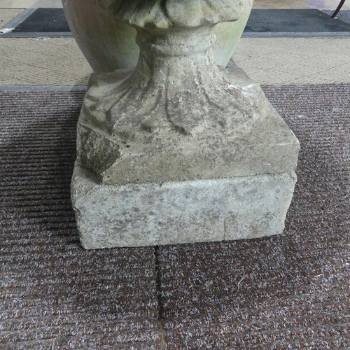 404 - A late 20th Century composite stone half fluted terrace vase or urn, on moulded plinth base and stan... 