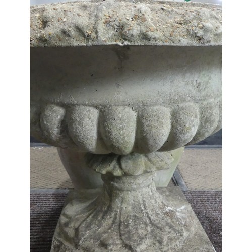 404 - A late 20th Century composite stone half fluted terrace vase or urn, on moulded plinth base and stan... 