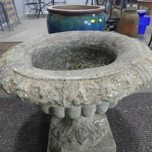 404 - A late 20th Century composite stone half fluted terrace vase or urn, on moulded plinth base and stan... 