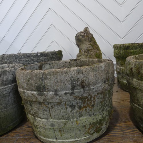 406 - A lot of five weathered reconstituted stone planters, shaped and carved to look like wooden barrels,... 