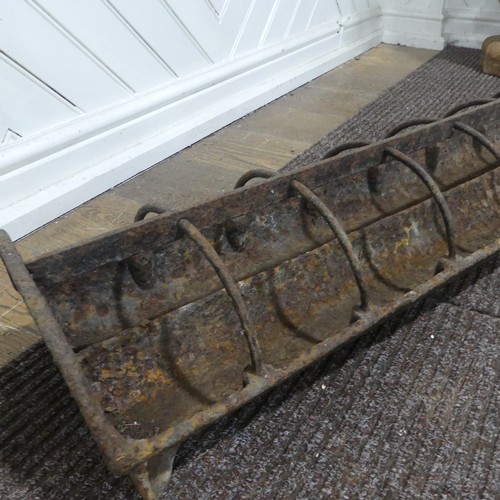 407 - An antique cast iron pig feeder, W 95 cm x H 18 cm x D 25 cm.