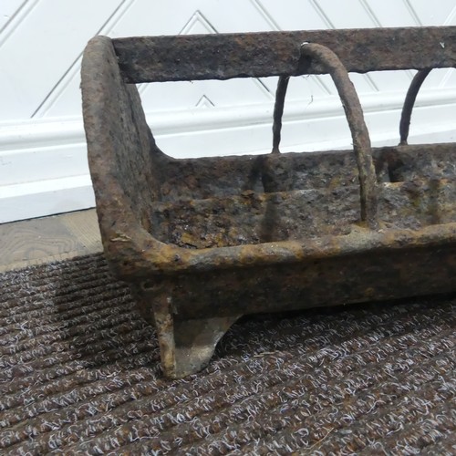 407 - An antique cast iron pig feeder, W 95 cm x H 18 cm x D 25 cm.