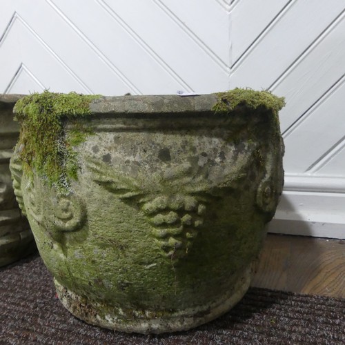 409 - A pair of weathered reconstituted stone Planters decorated with grape vines, together with another l... 