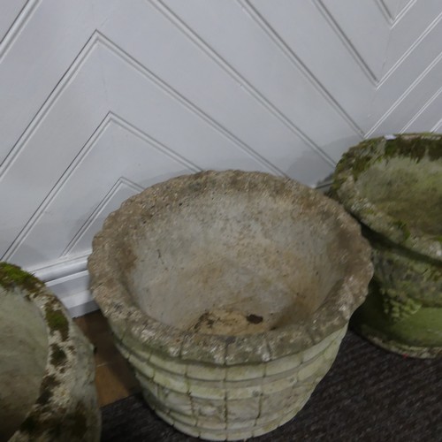 409 - A pair of weathered reconstituted stone Planters decorated with grape vines, together with another l... 