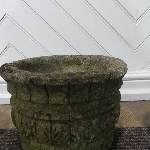 409 - A pair of weathered reconstituted stone Planters decorated with grape vines, together with another l... 