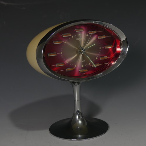 233 - A retro Rhythm (Japan) Alarm Clock, circa 1960s, with oval pink tinted face and chromed edge of case... 