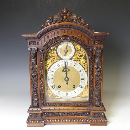 228 - A attractive late 19th century continental carved walnut Mantel Clock, with arched brass dial, silve... 