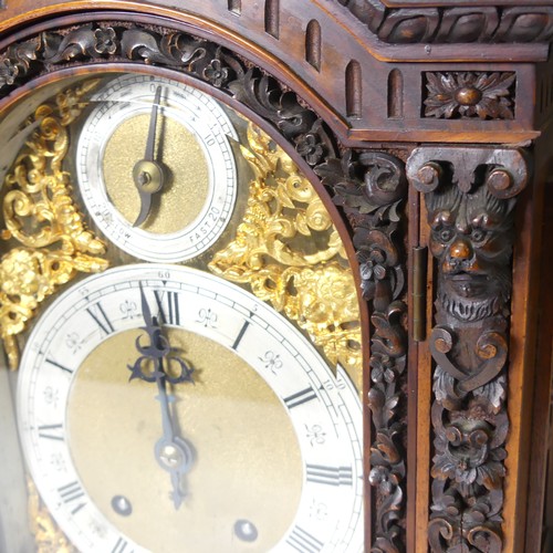 228 - A attractive late 19th century continental carved walnut Mantel Clock, with arched brass dial, silve... 