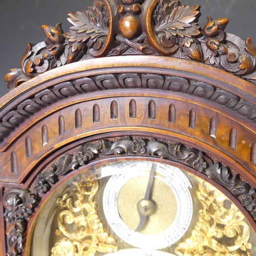 228 - A attractive late 19th century continental carved walnut Mantel Clock, with arched brass dial, silve... 