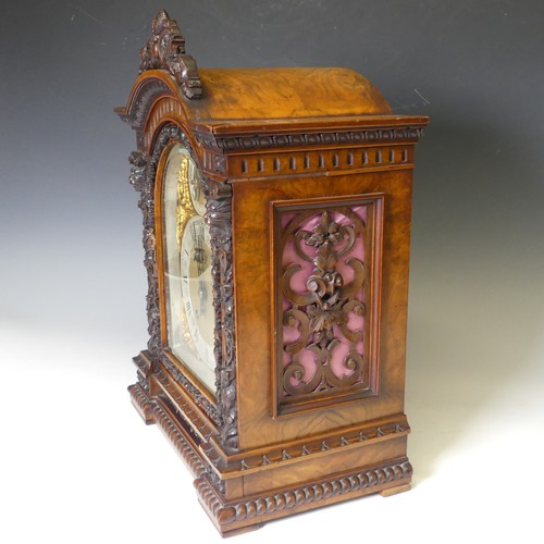 228 - A attractive late 19th century continental carved walnut Mantel Clock, with arched brass dial, silve... 