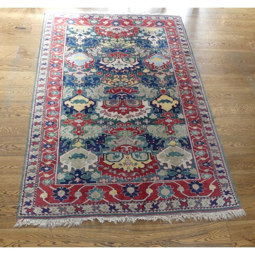 249 - Tribal Rugs: a Turkish hand knotted wool rug, the whole woven with bold geometric patterns in turquo... 