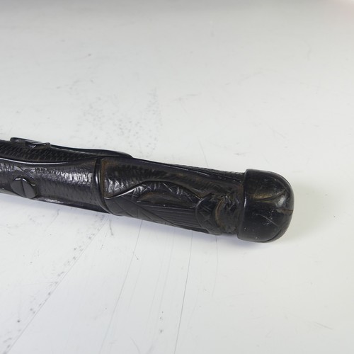 278 - An Early 20thC Irish bog oak walking cane, decorated with carved shamrock and a harp, bottom of cane... 