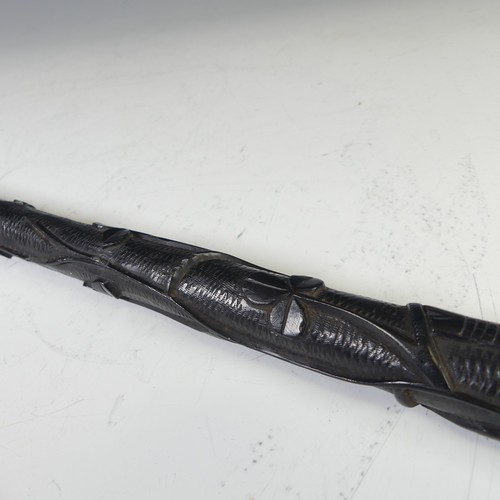 278 - An Early 20thC Irish bog oak walking cane, decorated with carved shamrock and a harp, bottom of cane... 