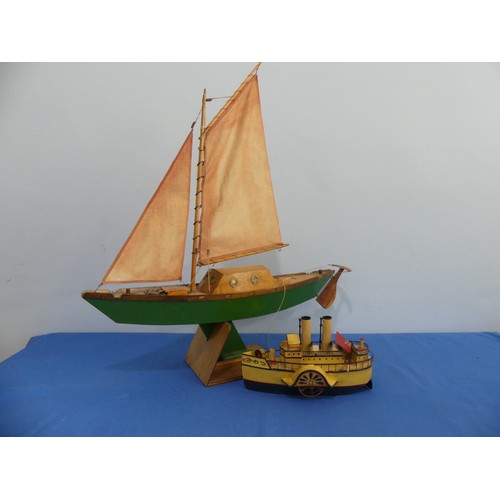 435 - A wooden model sailing yacht, with mask, sails, anchor, wooden rudder cabin with windows, painted gr... 