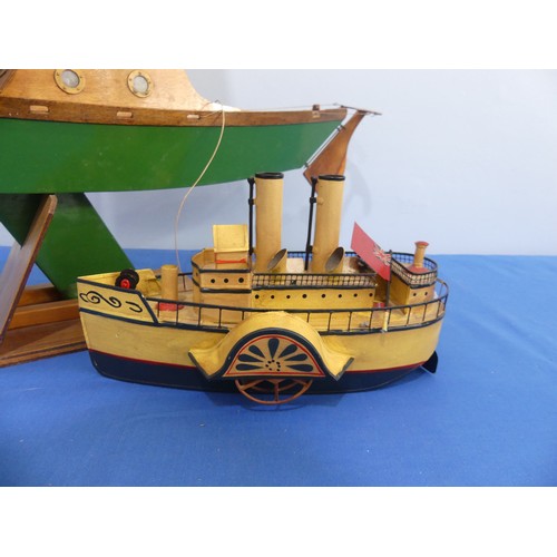 435 - A wooden model sailing yacht, with mask, sails, anchor, wooden rudder cabin with windows, painted gr... 